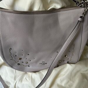 Coach hobo bag with gold tone floral embellishments